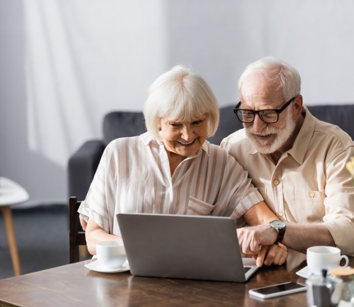 deux seniors qui naviguent sur internet avec leur ordinateur